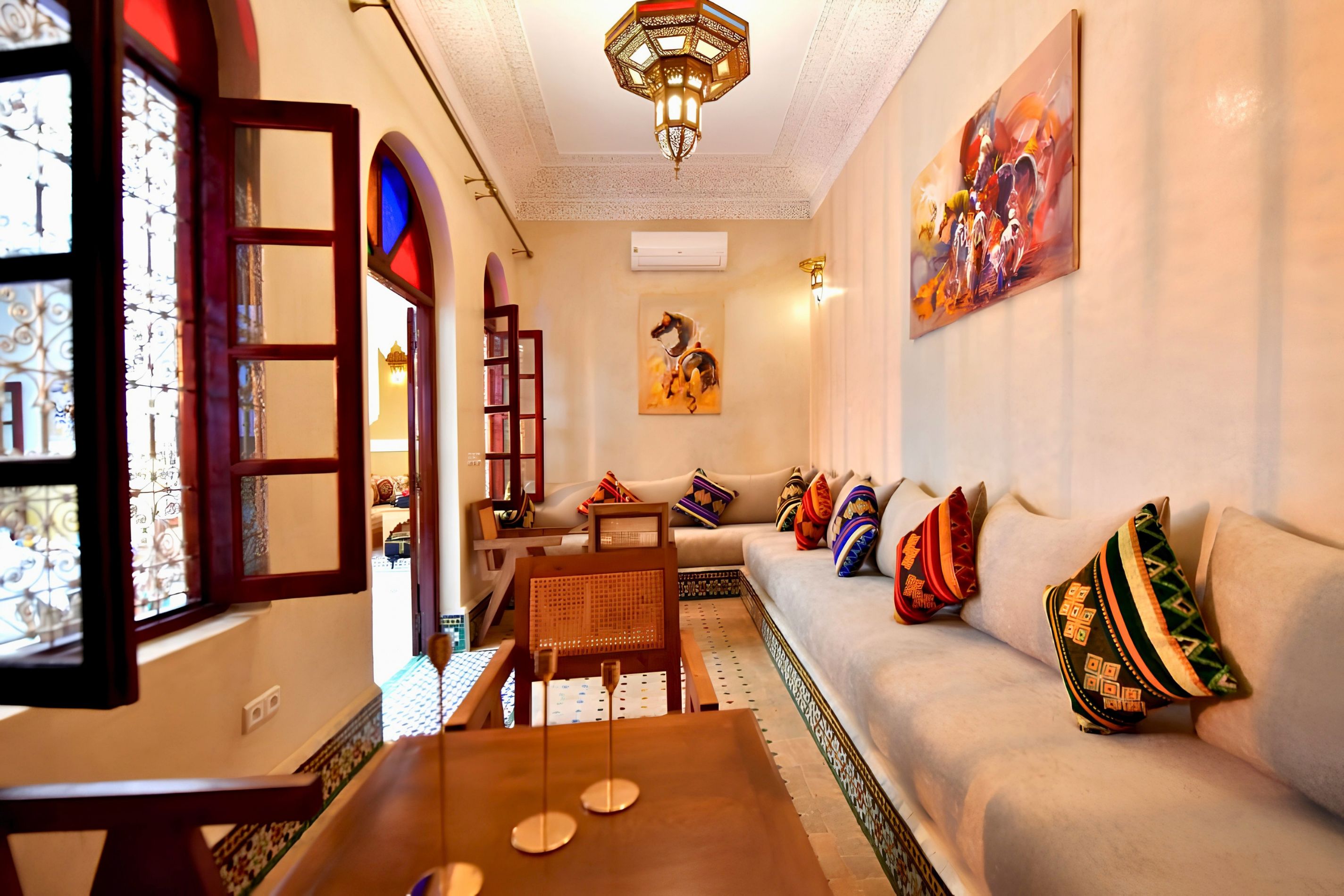 A living room with a sofa, a coffee table, and a painting on the wall.