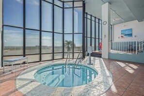 A pool area with a view of the beach, a bench, and a clock on the wall. - 3BR Beachfront condo w/ Gulf views, pools, hot tub and direct beach access (Orange Beach)