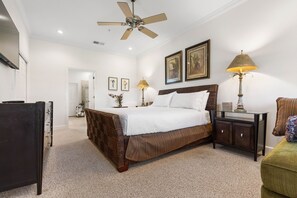 A bedroom with a bed, bedside lamps, a dresser, and a ceiling fan. - Cinnamon Beach 5th floor ocean condo 155 - incredible views! (Palm Coast)