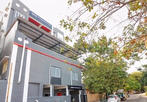 A modern building with a sign reading 'Oyo Townhouse'.