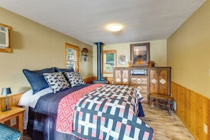 A bedroom with a bed, a dresser, a window, and a ceiling light. - Tetonka Lake Views & Outdoor Entertainment Area! (Waterville)