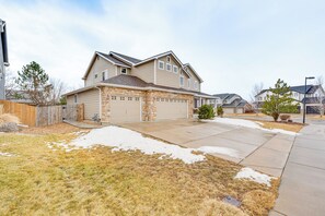 A two-story house with a stone foundation, a garage, and a front yard with snow patches. - 5,000 Sq Ft Luxury Mansion (Erie)