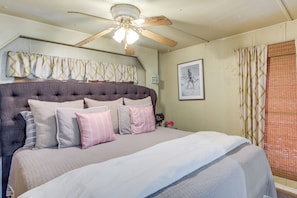 A bedroom with a large bed, a ceiling fan, and a window with curtains. - Walk to Beach & Dock! Lake Texoma Family Getaway (Kingston)