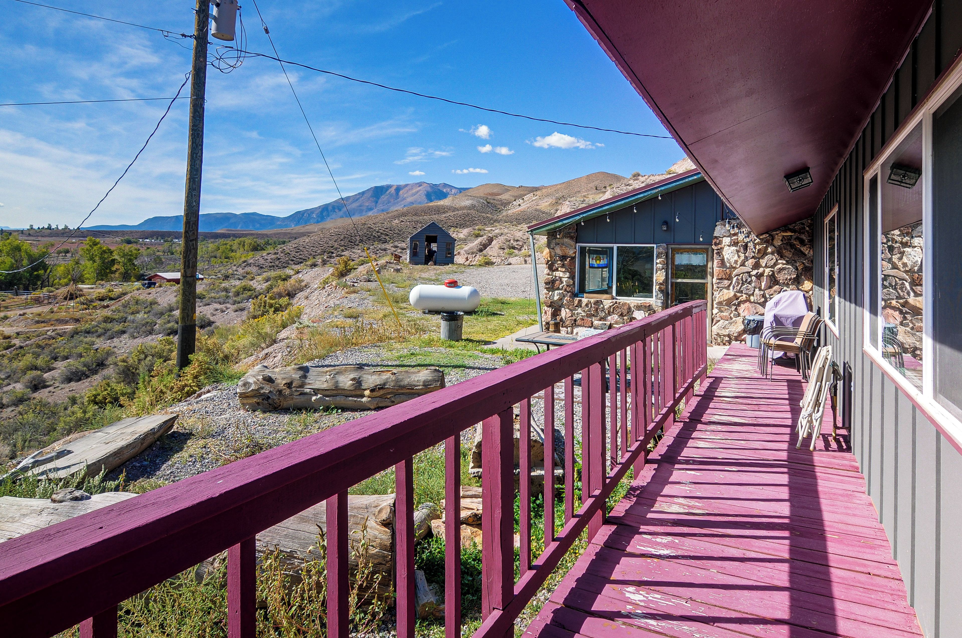 A wooden deck with a stone building in the background.