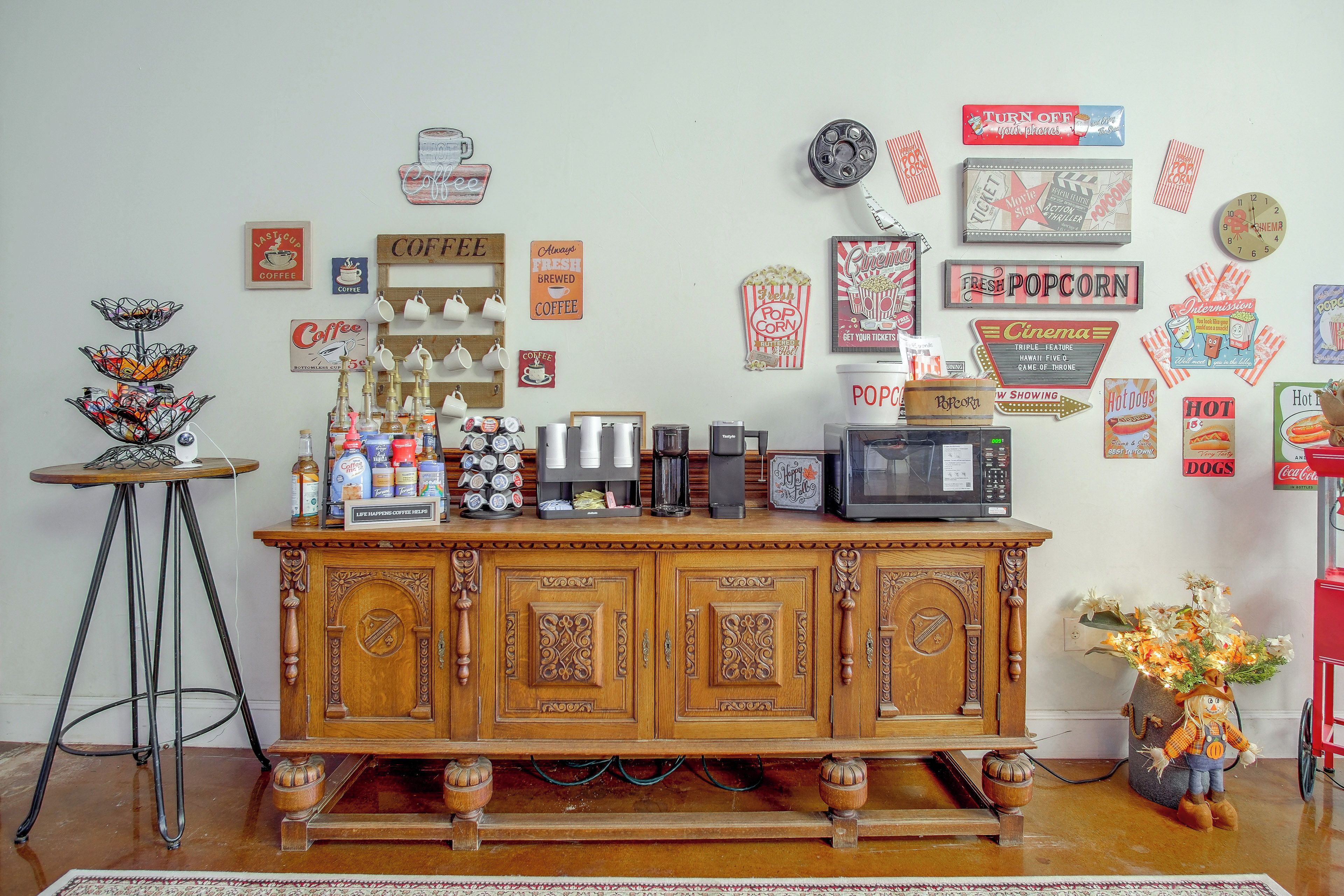 A coffee station with a variety of coffee makers and a popcorn machine.