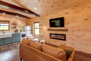 A cozy cabin interior with a kitchen, dining area, and living room.