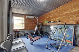A gym with exercise equipment, a window, and a map on the wall.