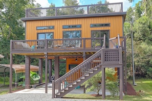 A two-story wooden building with a balcony and a staircase.