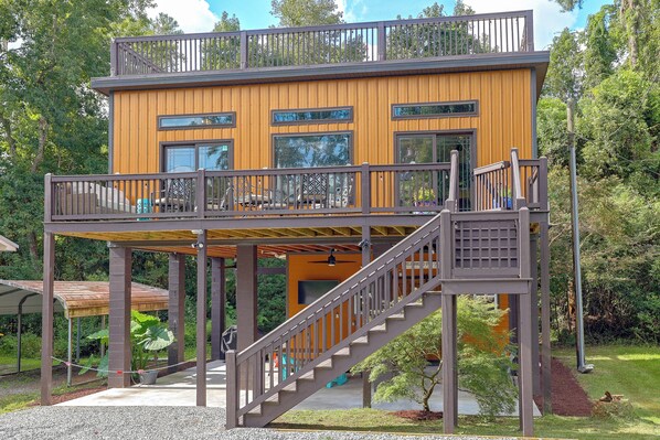 A two-story wooden building with a balcony and a staircase.