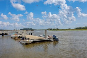 A dock with boats and a wooden pier extending into a body of water.