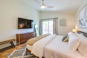 A bedroom with a bed, a TV mounted on the wall, a ceiling fan, and a window with curtains. - 3 Mi to Downtown! Sauna & Pool in Palm Springs (Palm Springs)