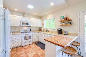 A modern kitchen with white cabinetry, a gas stove, a microwave, and a coffee machine. - 3 Mi to Downtown! Sauna & Pool in Palm Springs (Palm Springs)