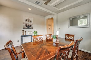 A dining room with a wooden table and chairs, a painting on the wall, and a mirror. - Hot Tub & Patio! Family Escape, 7 Mi to Seaworld (San Antonio)