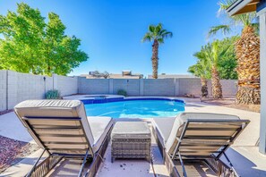A backyard with a swimming pool, lounge chairs, and a palm tree. - Chandler Haven Near Golf, Sports & Shopping! (Chandler)