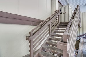 A wooden staircase with a metal handrail leading to a landing. - Breckenridge Ski Condo: Easy Bus to Slopes (Breckenridge)