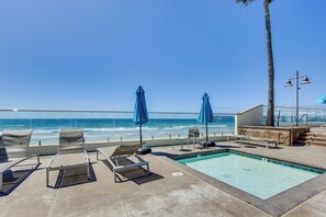 A poolside area with lounge chairs and umbrellas, overlooking the ocean. - Beach + Poolside Days! Extended Coronado Escape (Coronado)