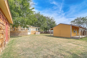 A residential property with a wooden deck, a small house, and a fenced yard. - Private Workout Studio & Fenced Yard! Tulsa Escape (Tulsa)