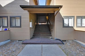 A staircase leading to a building entrance with a metal handrail and a small landing area. - 1 Mi to Sunriver Resort! Studio w/ Hot Tub Access (Bend)