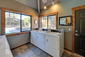 A laundry room with two washing machines, a dryer, and a window with a view of trees and a building outside. - 1 Mi to Sunriver Resort! Studio w/ Hot Tub Access (Bend)