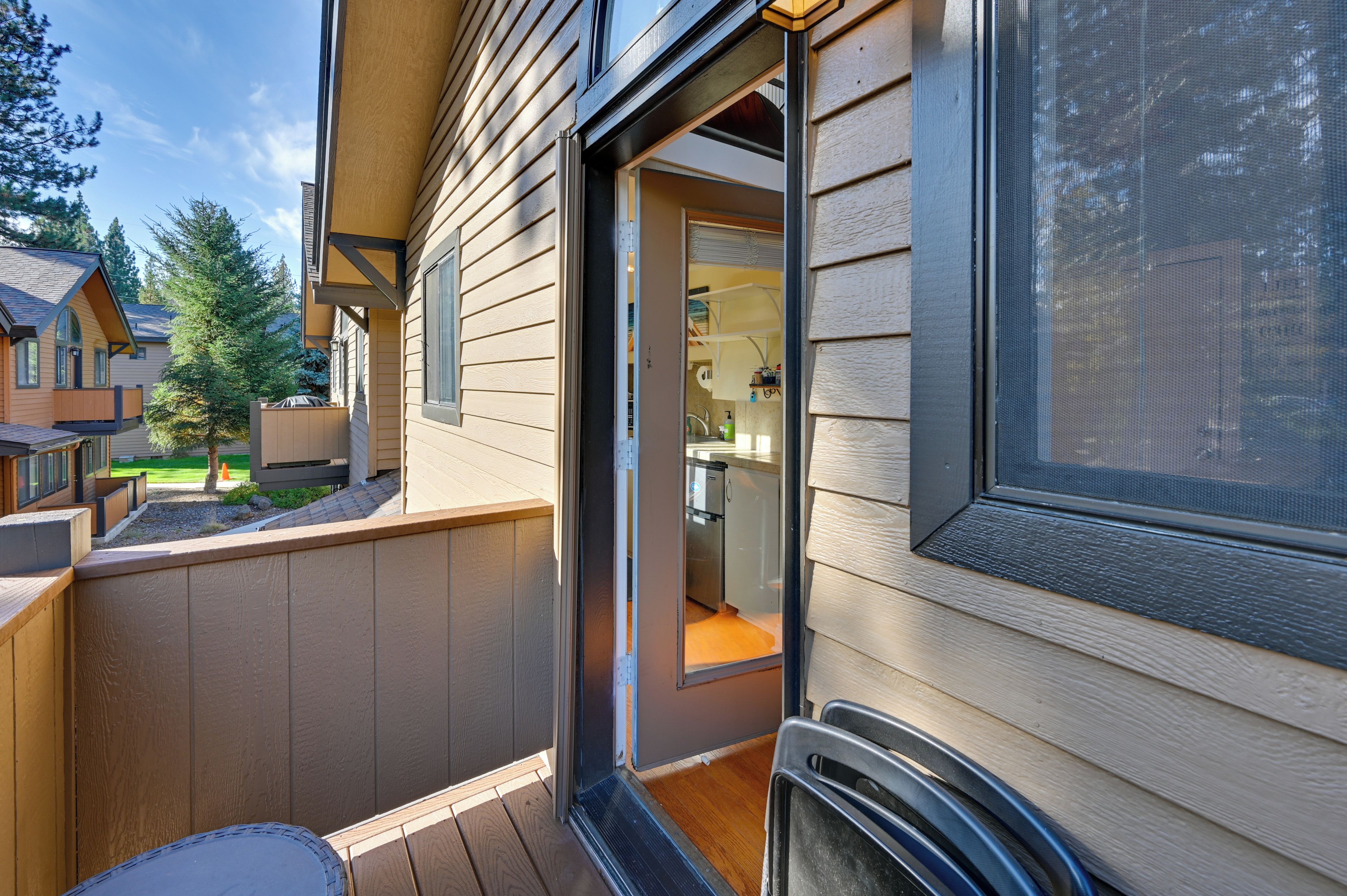 A residential building with a visible entryway leading to a kitchen area.