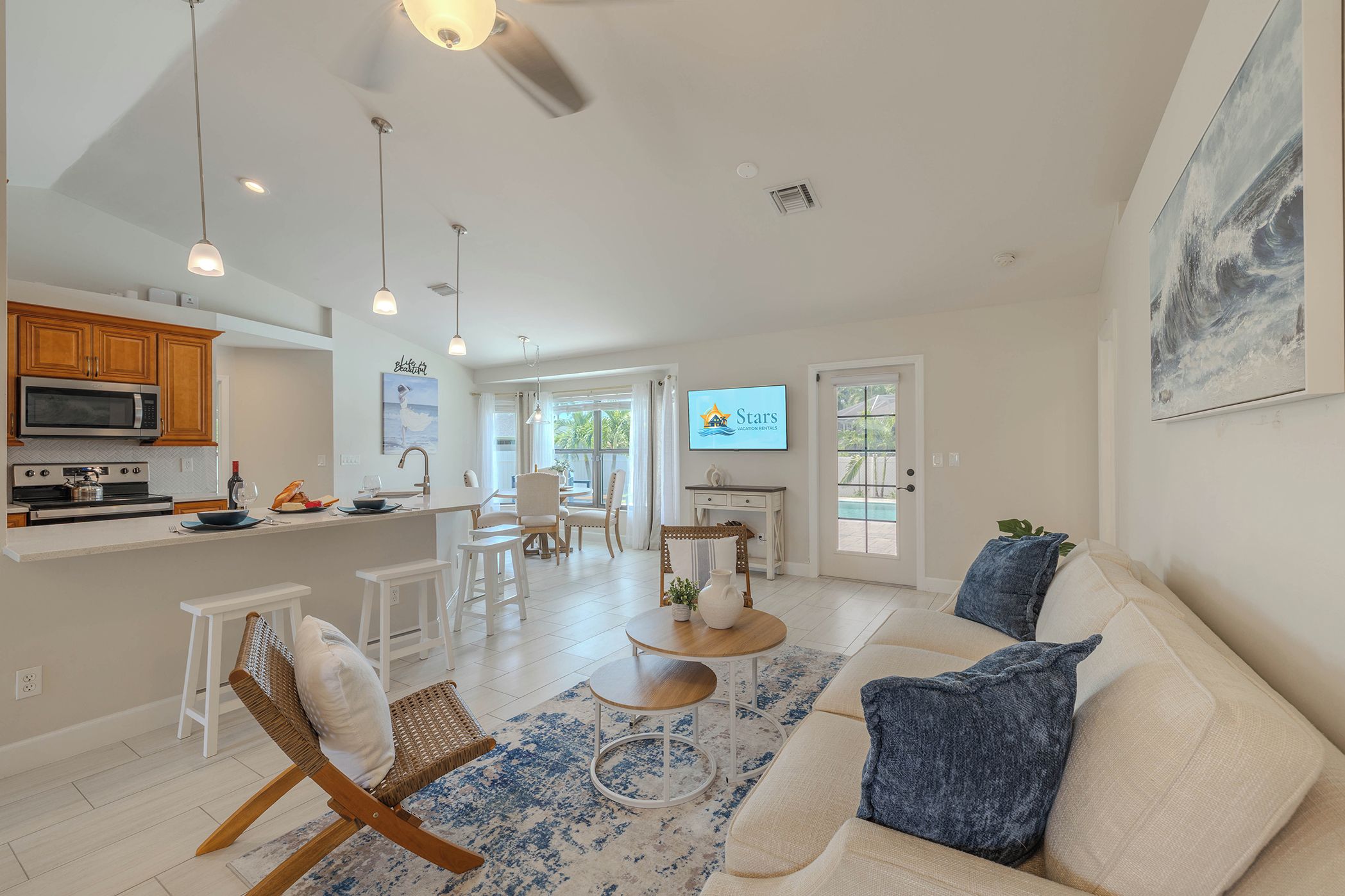 A spacious living area with a sofa, a dining table, and a kitchen area with modern appliances.