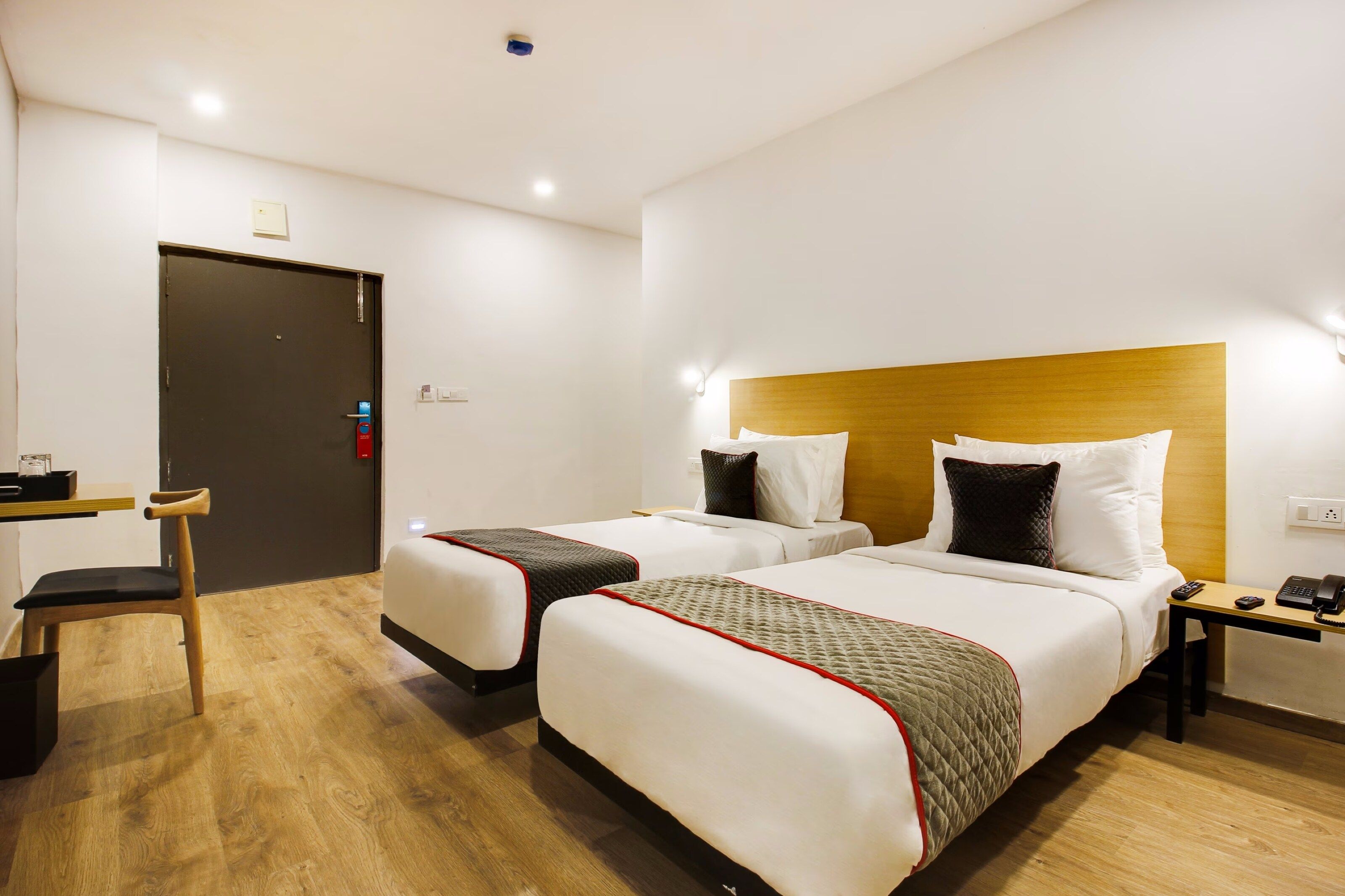 Una habitación de hotel con dos camas, un escritorio y una silla.