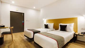 Una habitación de hotel con dos camas, un escritorio y una silla.