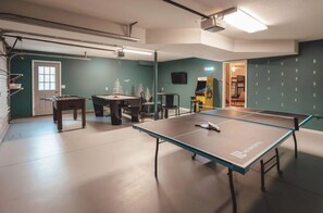 A room with a ping pong table, a foosball table, and a pool table. - Bigfoot's Hideout - Cabin-Game Room Sleeps 10 (Logan)