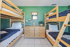 A room with bunk beds, a dresser, and a mirror. - Oyster Bay Escape | Private Dock, Ramp & Kayak (New Port Richey)
