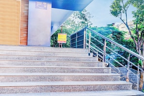 A set of outdoor stairs leading up to a building with a metal handrail. - Super Townhouse SR Nagar Near  (Hyderabad)