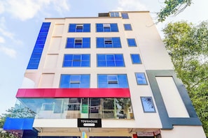 A multi-story building with a sign indicating it is a serviced company property. - Super Townhouse SR Nagar Near  (Hyderabad)
