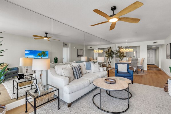 A spacious living room with a white sofa, a coffee table, and a ceiling fan. - Pool, Hot Tub, Beach Area | Intracoastal Views | Bahia Vista 529 - Bahia Breeze (St. Petersburg)