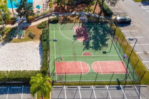 An aerial view of a basketball court with a surrounding fence, trees, and a parking lot. - Close To Disney Condo 3 Bed / 2 Bath 3 Bedroom Condo (Kissimmee)