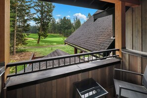 A wooden balcony with a view of a golf course. - Private Pool! Stunning View Overlooking Hole #4 on the Rope Rider Golf Course (Cle Elum)