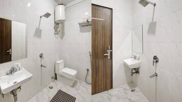 A modern bathroom with a toilet, sink, shower, and a wooden door.