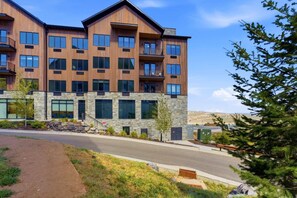 A multi-story building with a stone facade and large windows. - Pioche Basecamp | Deer Valley + Mountain Views (Park City)