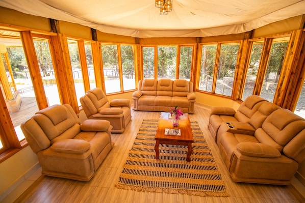 A cozy room with a sofa set, a coffee table, and a rug.