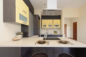 A modern kitchen with a central island, built-in appliances, and a minimalist design. - Warsaw | Biały Kamień 2 | Bright apartment | Free Parking (Warszawa)