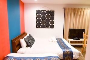 A hotel room with a bed, a television, a chair, and a wall-mounted artwork. - One More Heart Kyoto Station South 4 (Kyoto)