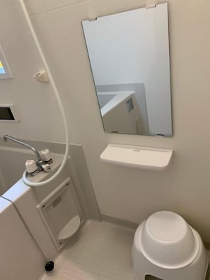 A bathroom with a white sink, mirror, and toilet. - One More Heart Kyoto Station South 4 (Kyoto)