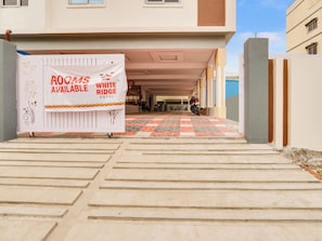 A hotel entrance with a banner advertising available rooms at White Ridge Hotel. - Collection O White Ridge Kamineni (Hyderabad)