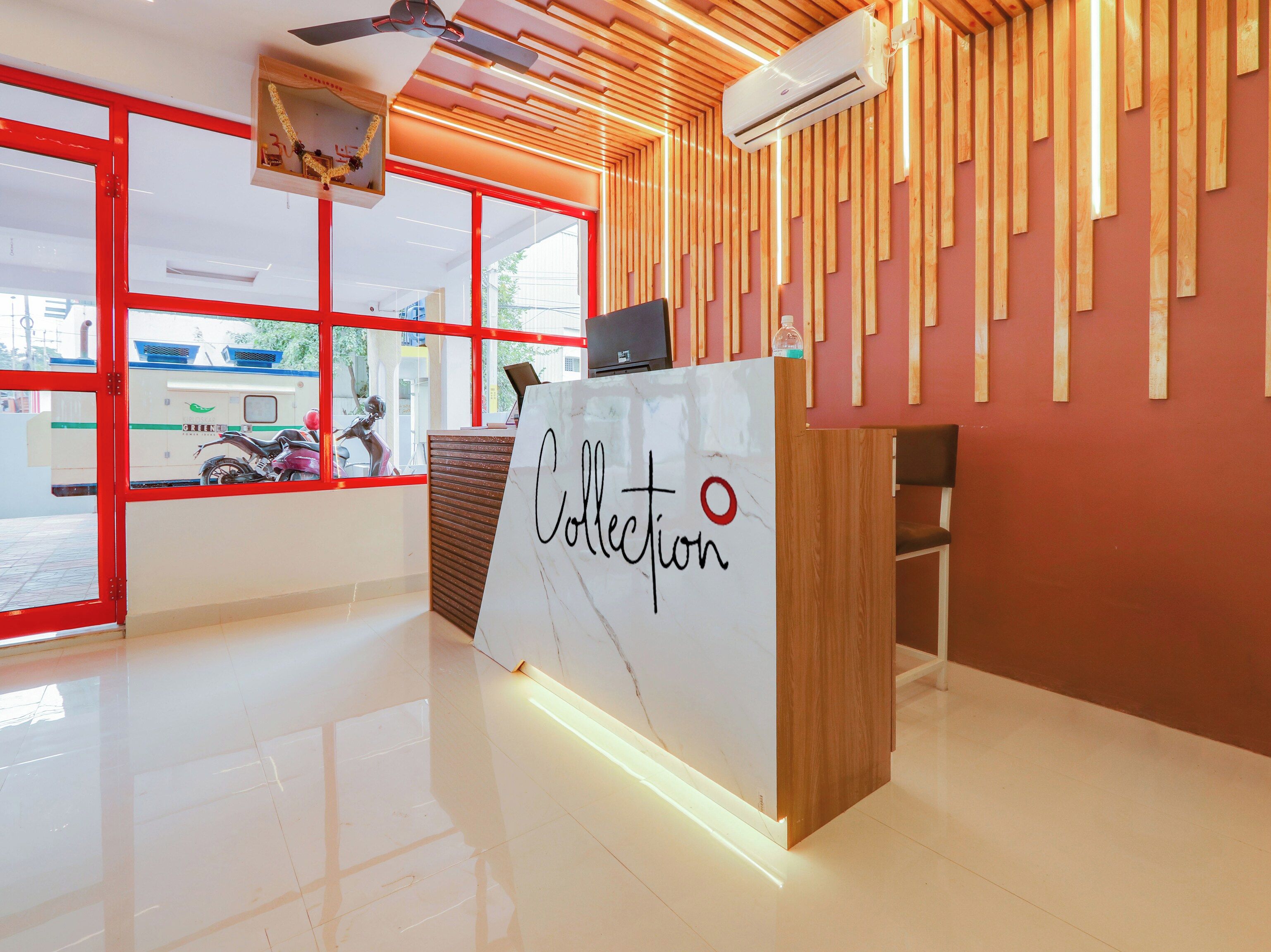 A reception desk with a marble top and the word 'Collection' written on it.