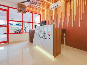 A reception desk with a marble top and the word 'Collection' written on it. - Collection O White Ridge Kamineni (Hyderabad)