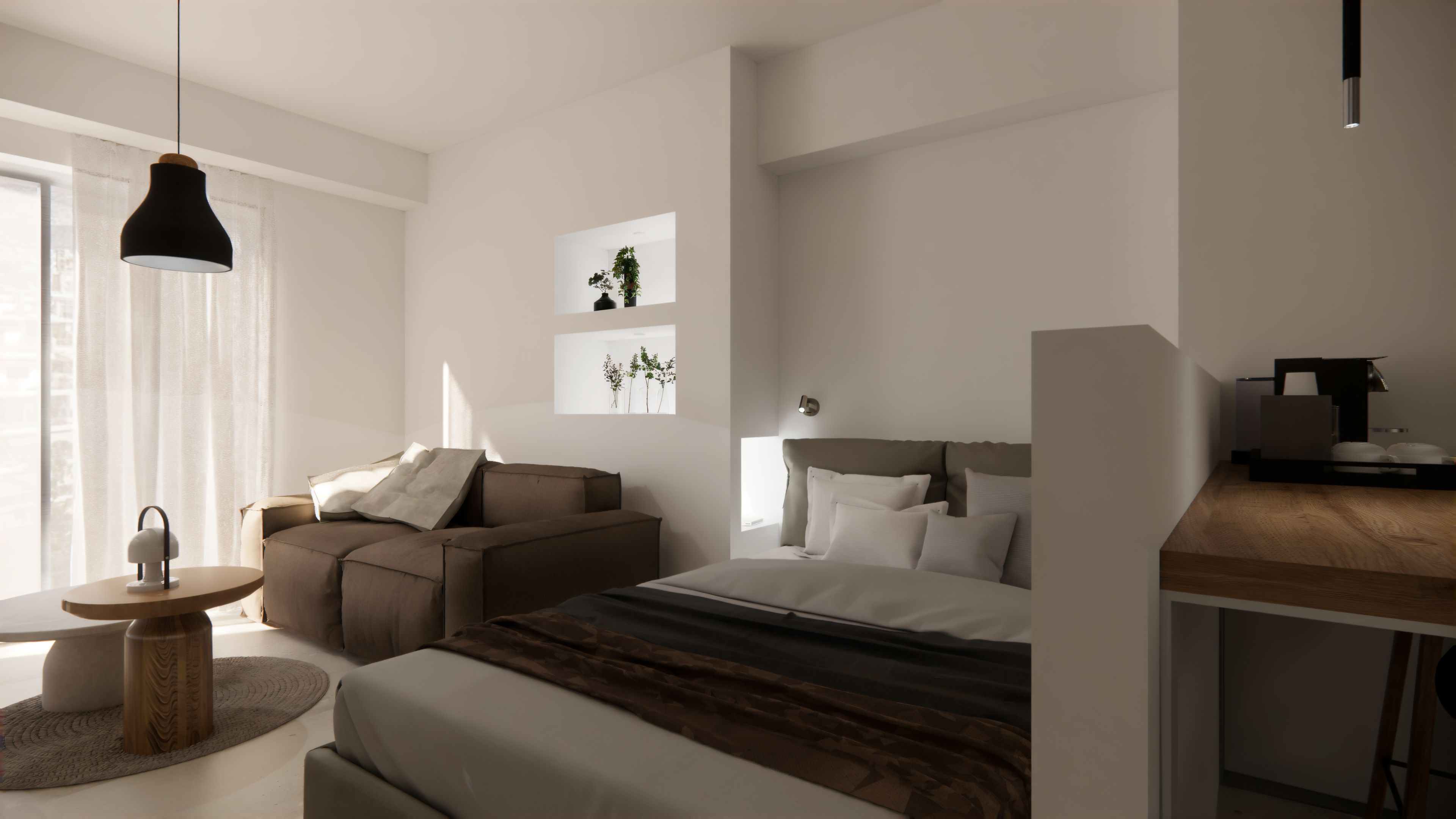 Une chambre moderne comprenant un lit, un canapé, une petite table et un espace bureau.