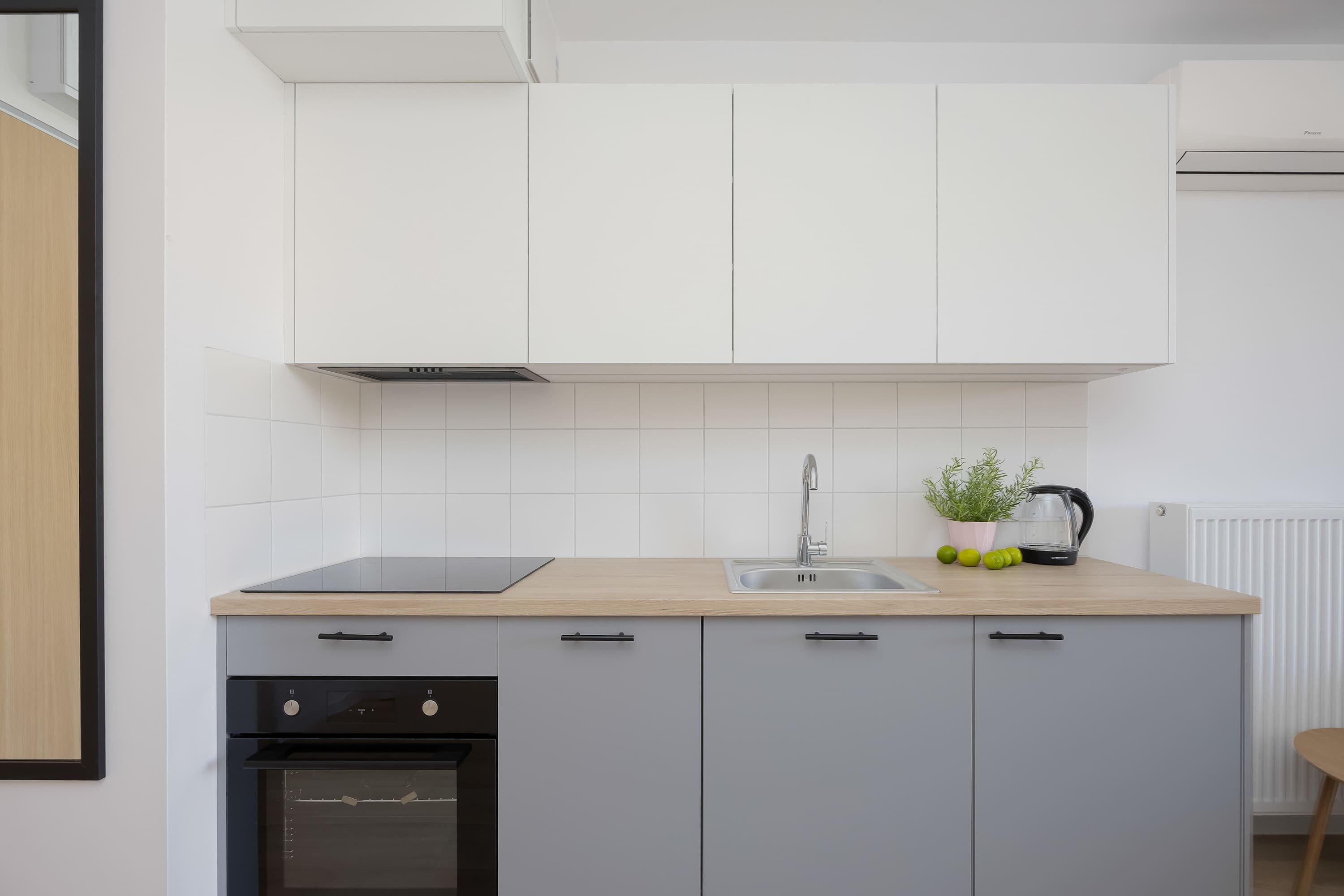 A modern kitchen with a built-in oven, a sink, and a countertop.