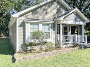 A single-story house with a front porch, a small front yard, and a brick foundation. - 114 - Modern 3BR Home (Gastonia)