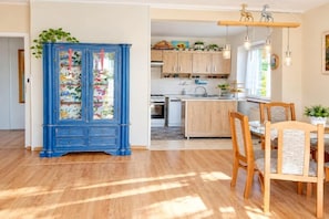 A room with a blue cabinet, wooden dining table, and chairs. - Large holiday apartment in Wisełka (Wisełka)