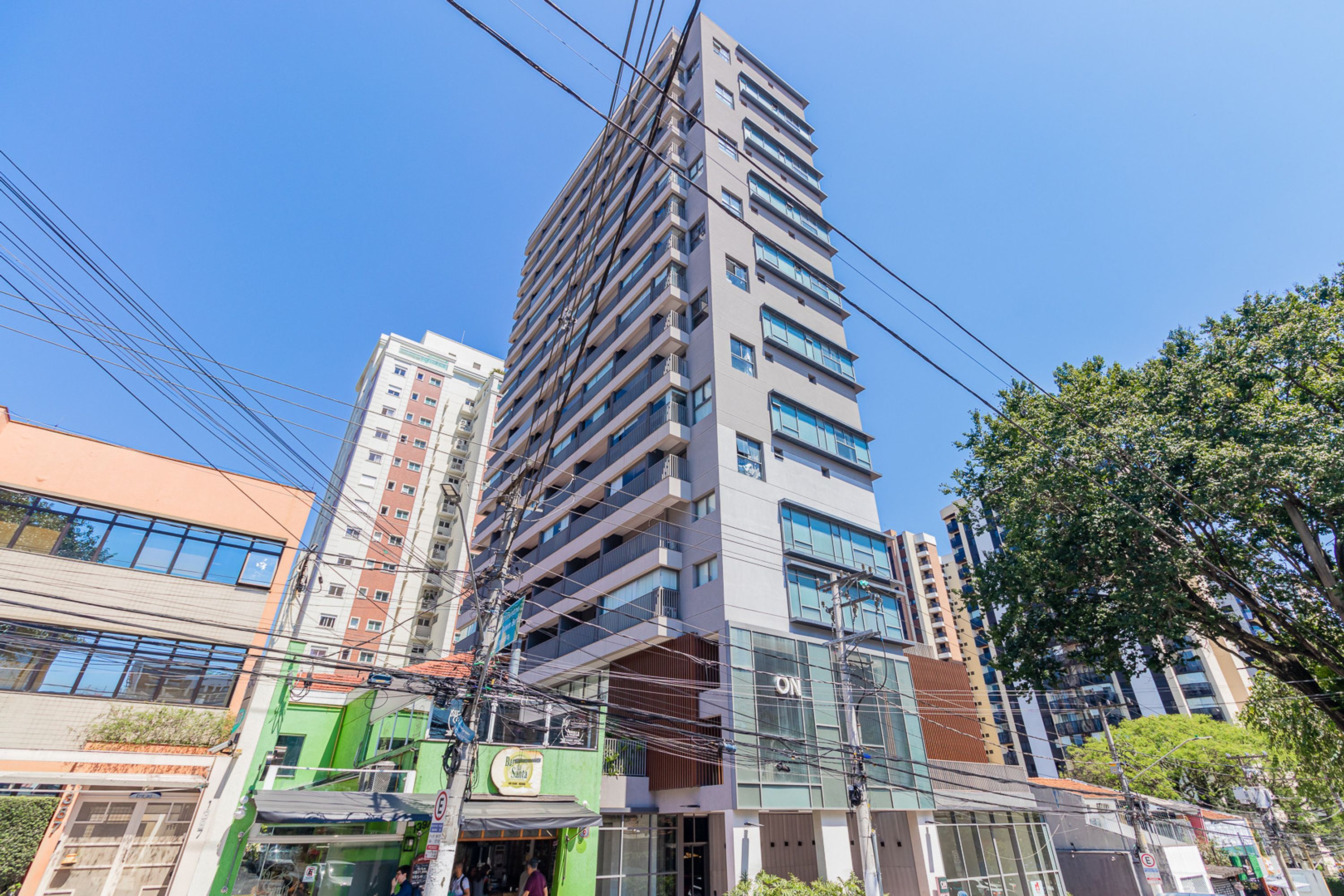 A multi-story building with a modern architectural design, featuring a mix of glass and metal facade elements.