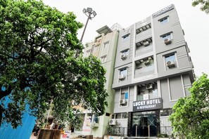 Un edificio de varios pisos con un letrero que dice 'Lucky Hotel & Restaurant' en la planta baja.