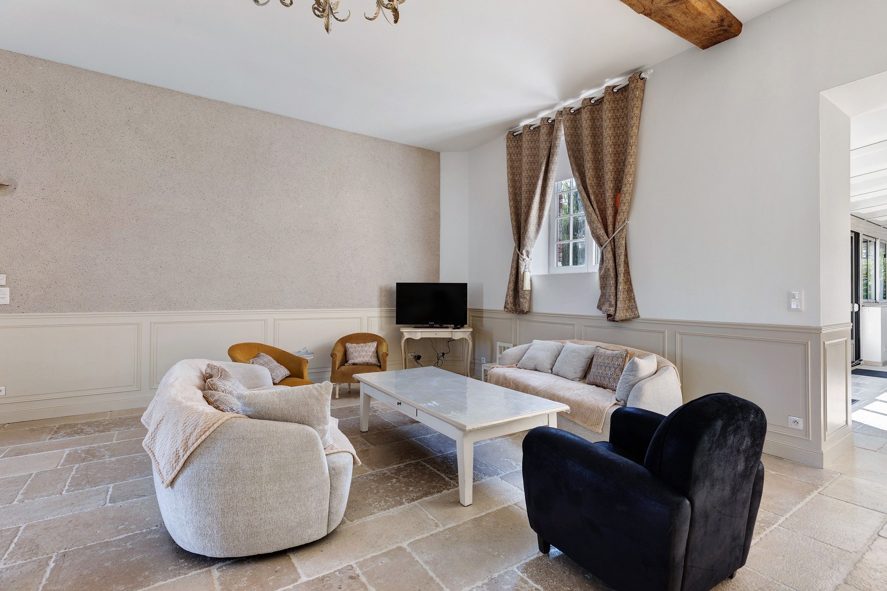 A living room with a sofa set, a coffee table, and a television.